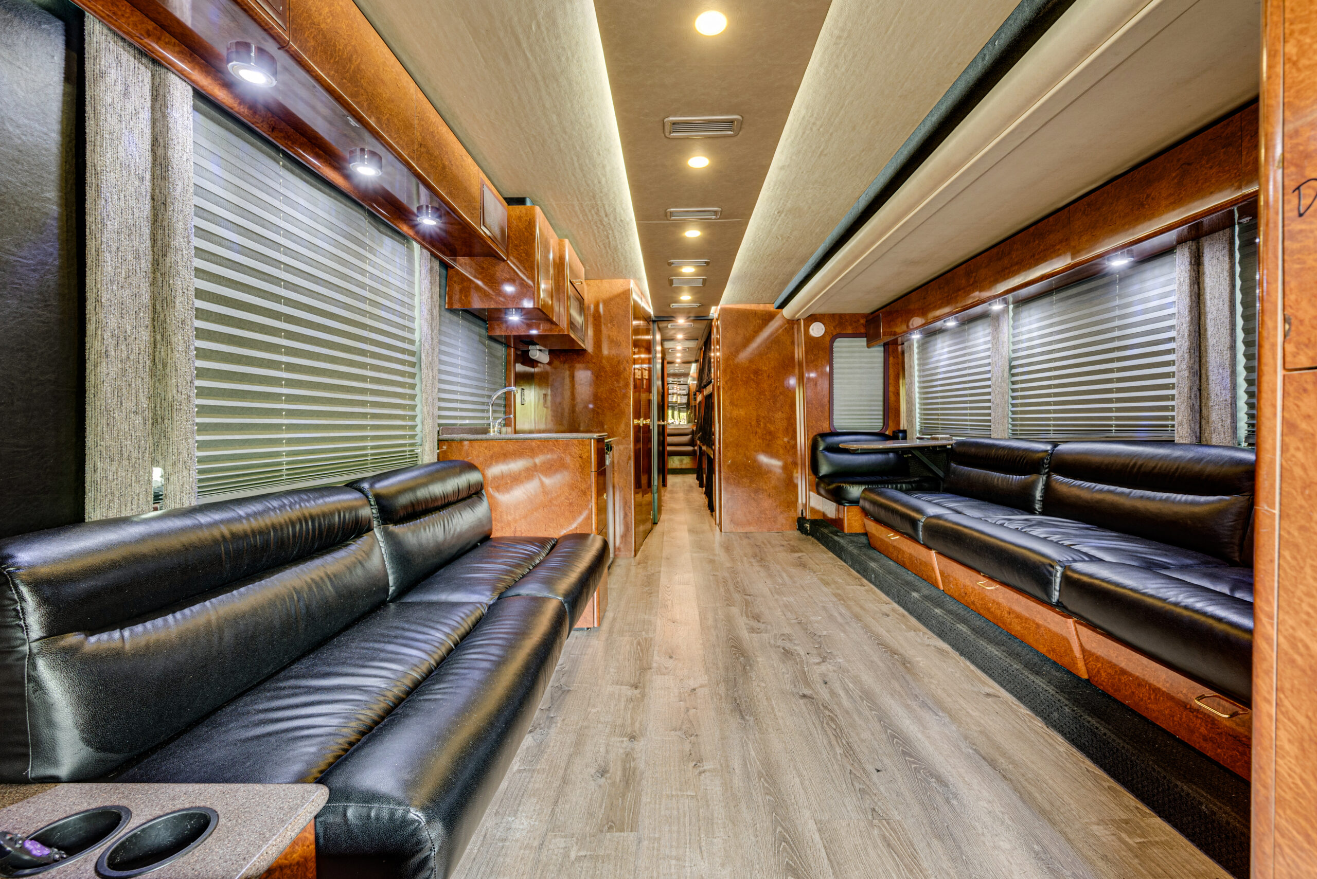 Interior of a 2004 Prevost XLII showcasing leather seating, beautiful lighting, and much more