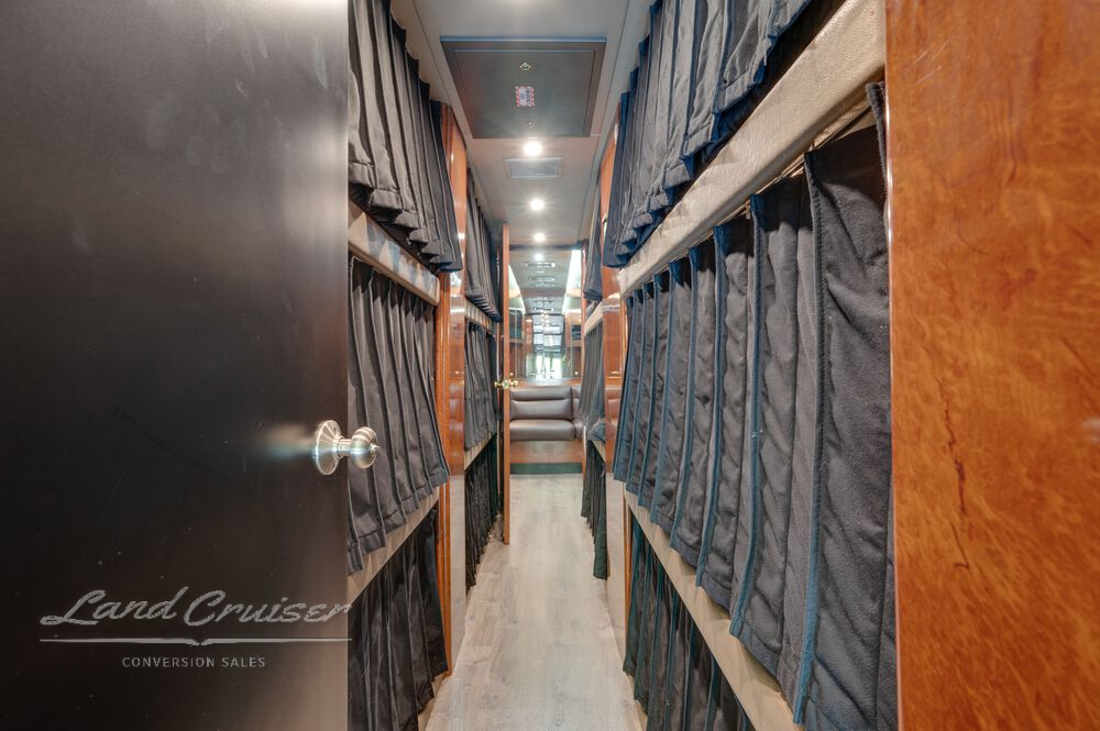 12-bunk hallway in Prevost coach with privacy curtains and LED overhead lighting