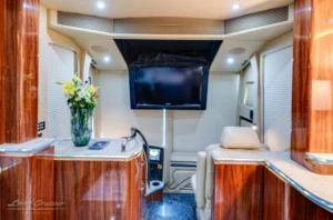 Entertainment bay with flatscreen TV in executive Prevost bus conversion
