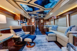 Spacious salon of Prevost bus conversion with skylight ceiling and leather seating