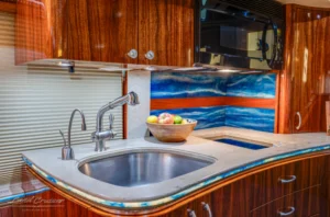 Designer galley sink and backsplash inside Prevost luxury motorhome for sale