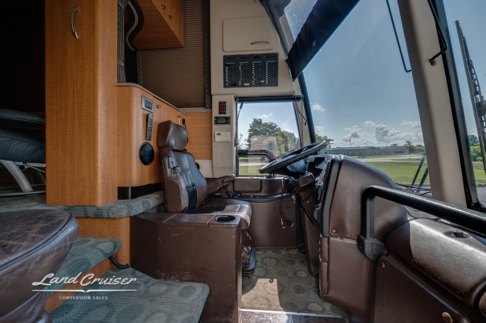 Driver cockpit area with wide-angle windshield, console, and instrumentation visible.