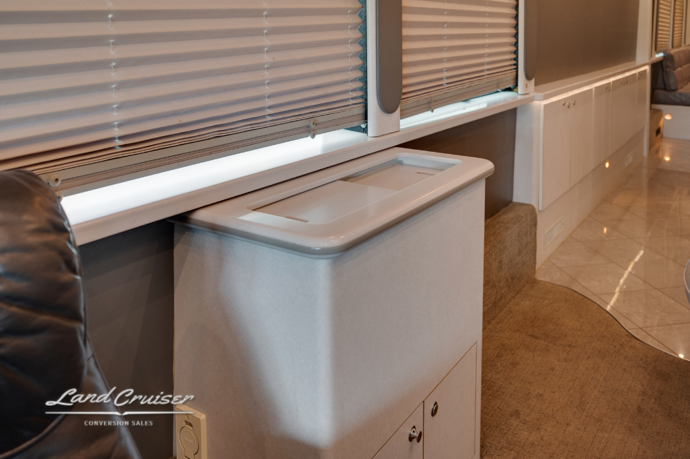 Compact refreshment station with hidden trash drawer and countertop inside Prevost XLII VIP bus