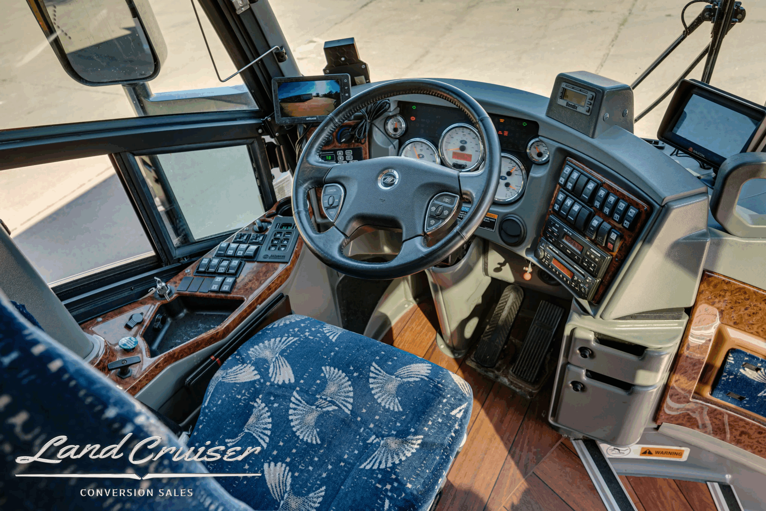 Driver cockpit with steering wheel, gauges, and controls.