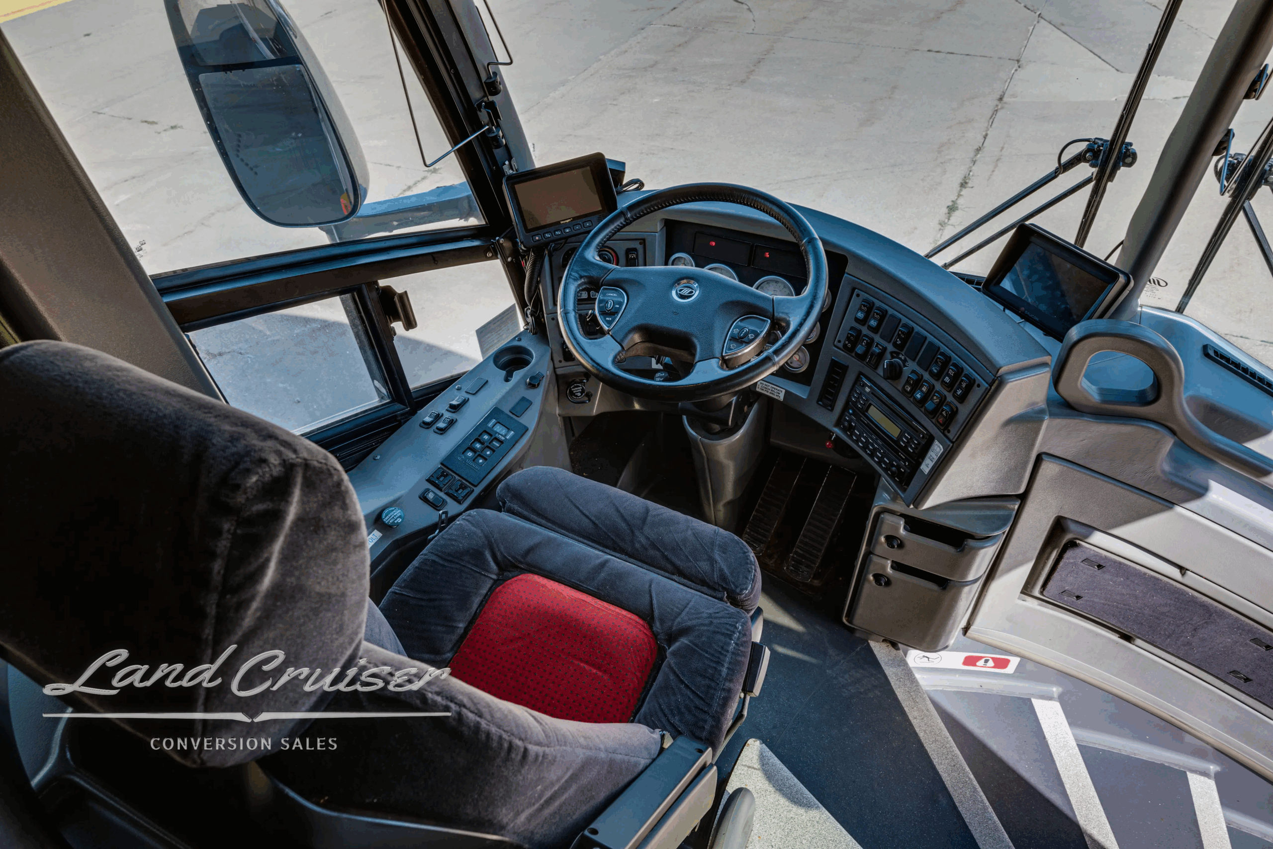 Steering wheel and dashboard with backup monitor and controls.
