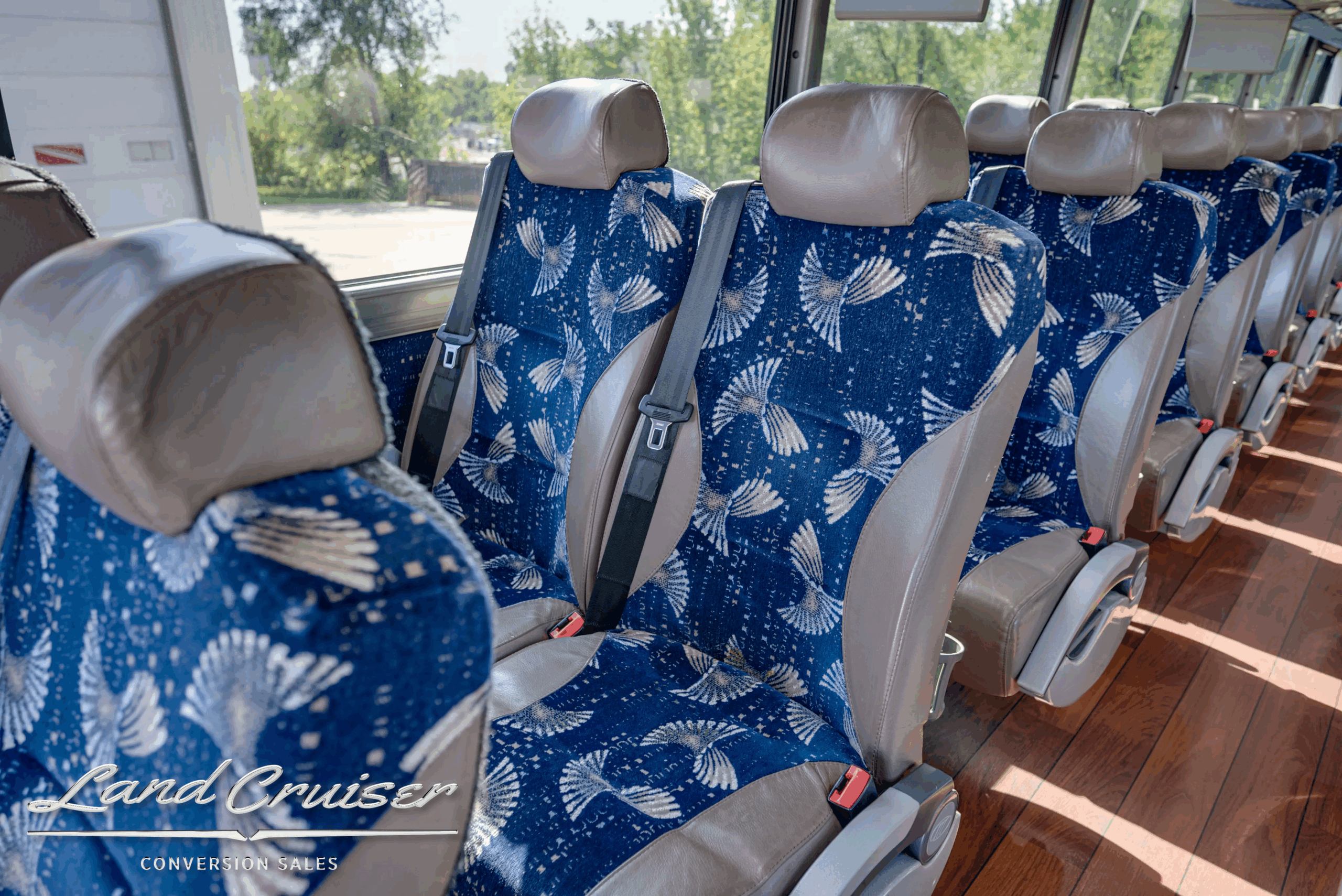 Pair of coach seats with blue patterned upholstery.